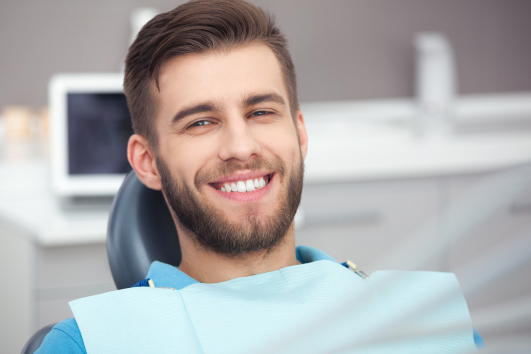 Smiling dental patient after getting treated by our emergency dentist in Tulsa, OK